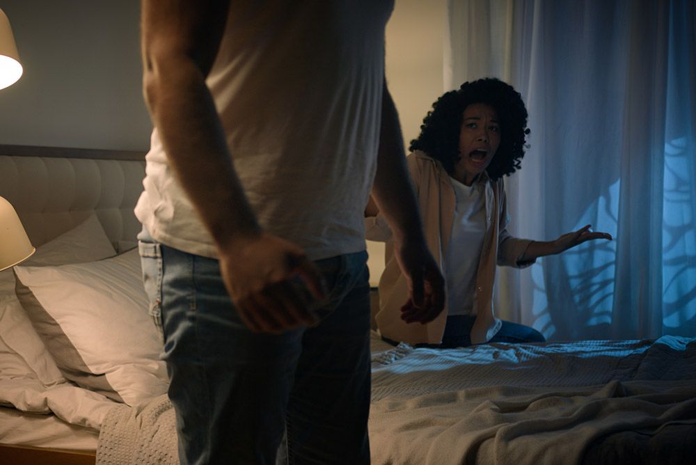 Image depicting domestic abuse, man and woman in bedroom