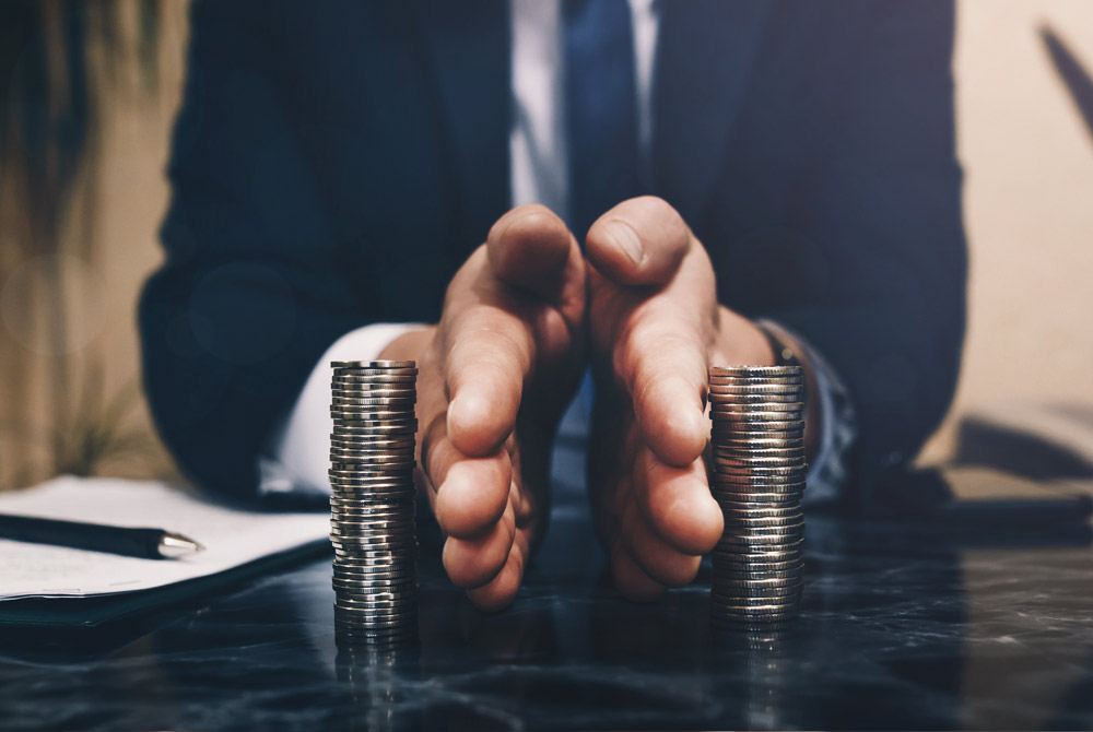 Splitting assets, man is dividing stacks of money